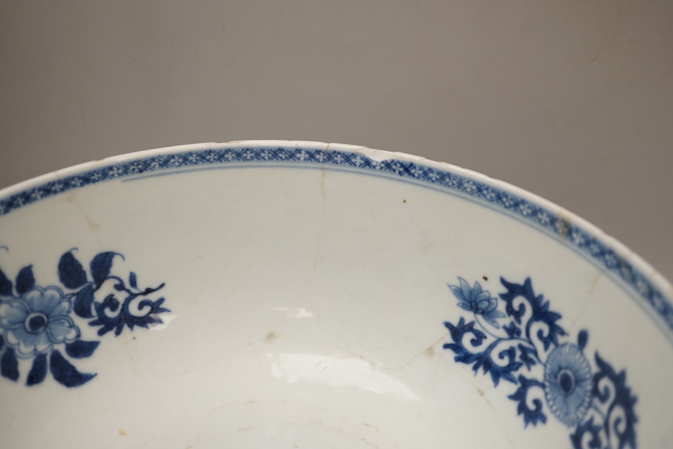Four 18th century Chinese porcelain bowls (a.f), one with hardwood stand, largest 28cm diameter